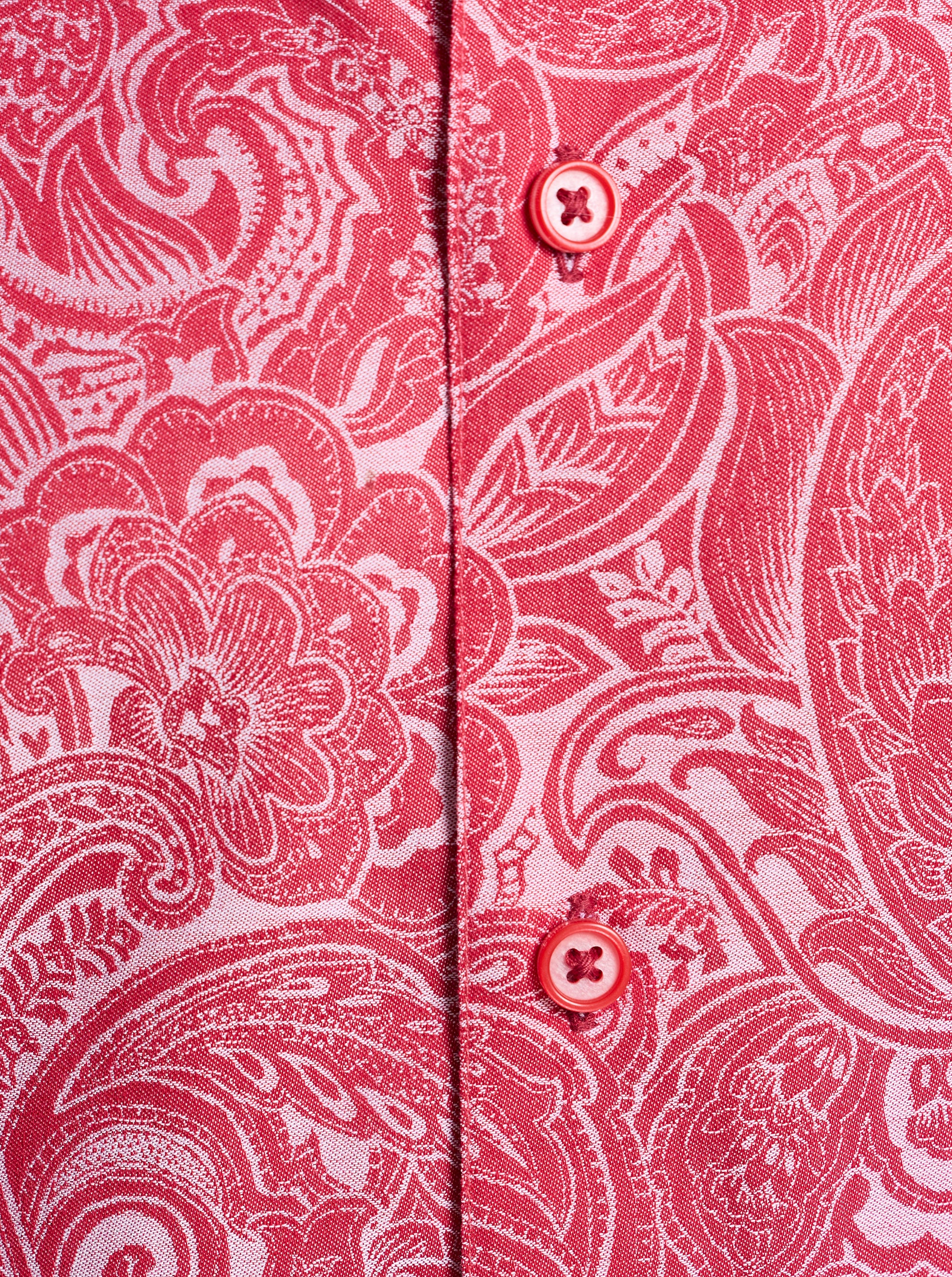 Close-up of a red and white paisley patterned shirt with buttons.
