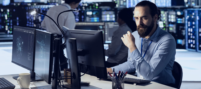 NOC engineer monitoring real-time systems in high-tech control center
